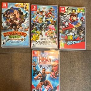4 Nintendo switch games in the original box.